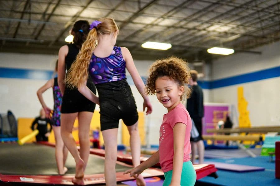 Children practicing gymnastics in a training gym