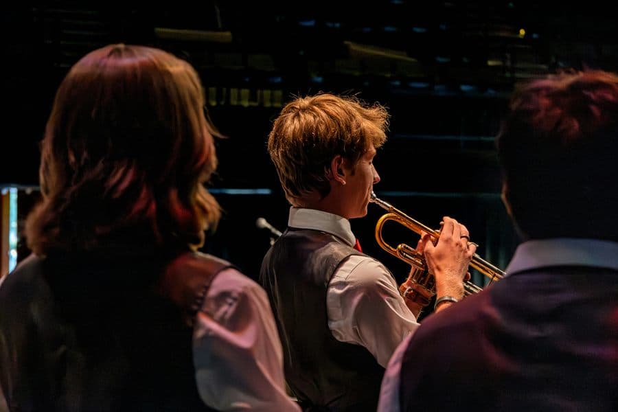 Young musician playing trumpet in an ensemble